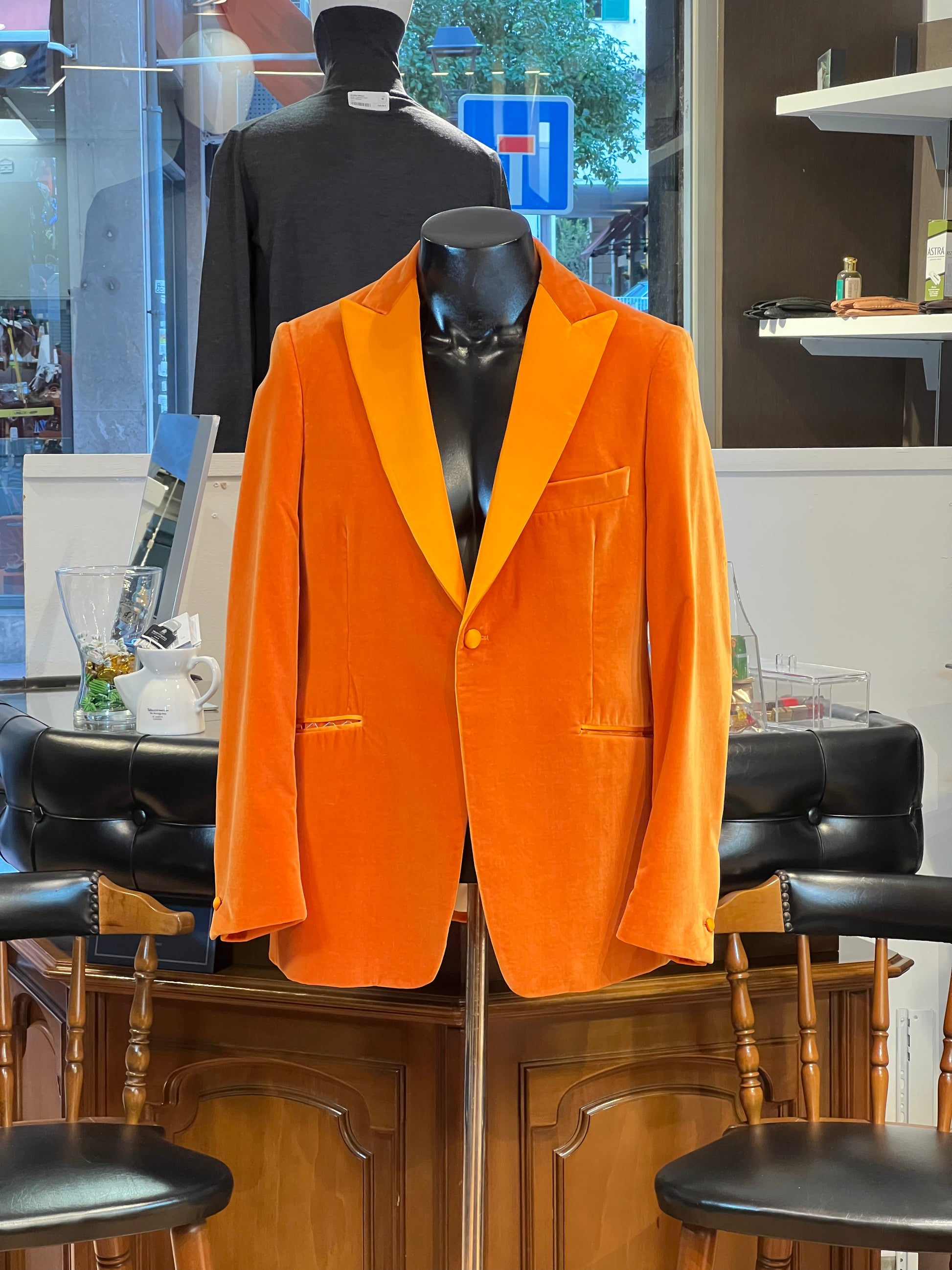 Luxury orange velvet blazer by John Blond, handcrafted with Carnet Como fabric, featuring contrasting amber peak lapels, covered buttons, and ivory satin lining — elegant statement jacket for formal or evening wear