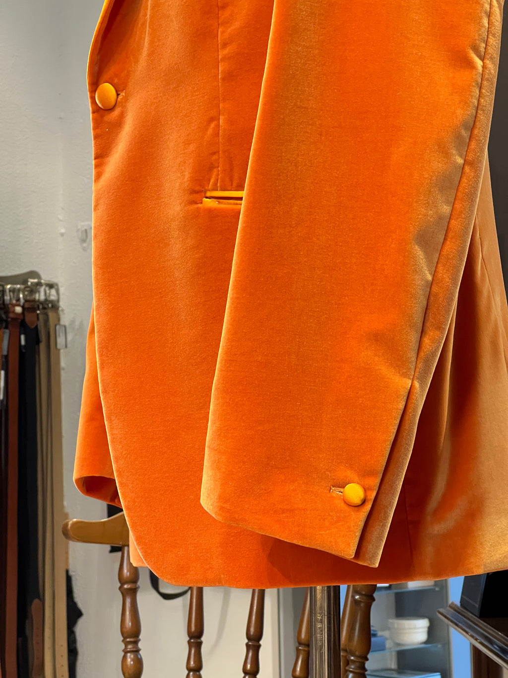 Luxury orange velvet blazer by John Blond, handcrafted with Carnet Como fabric, featuring contrasting amber peak lapels, covered buttons, and ivory satin lining — elegant statement jacket for formal or evening wear.