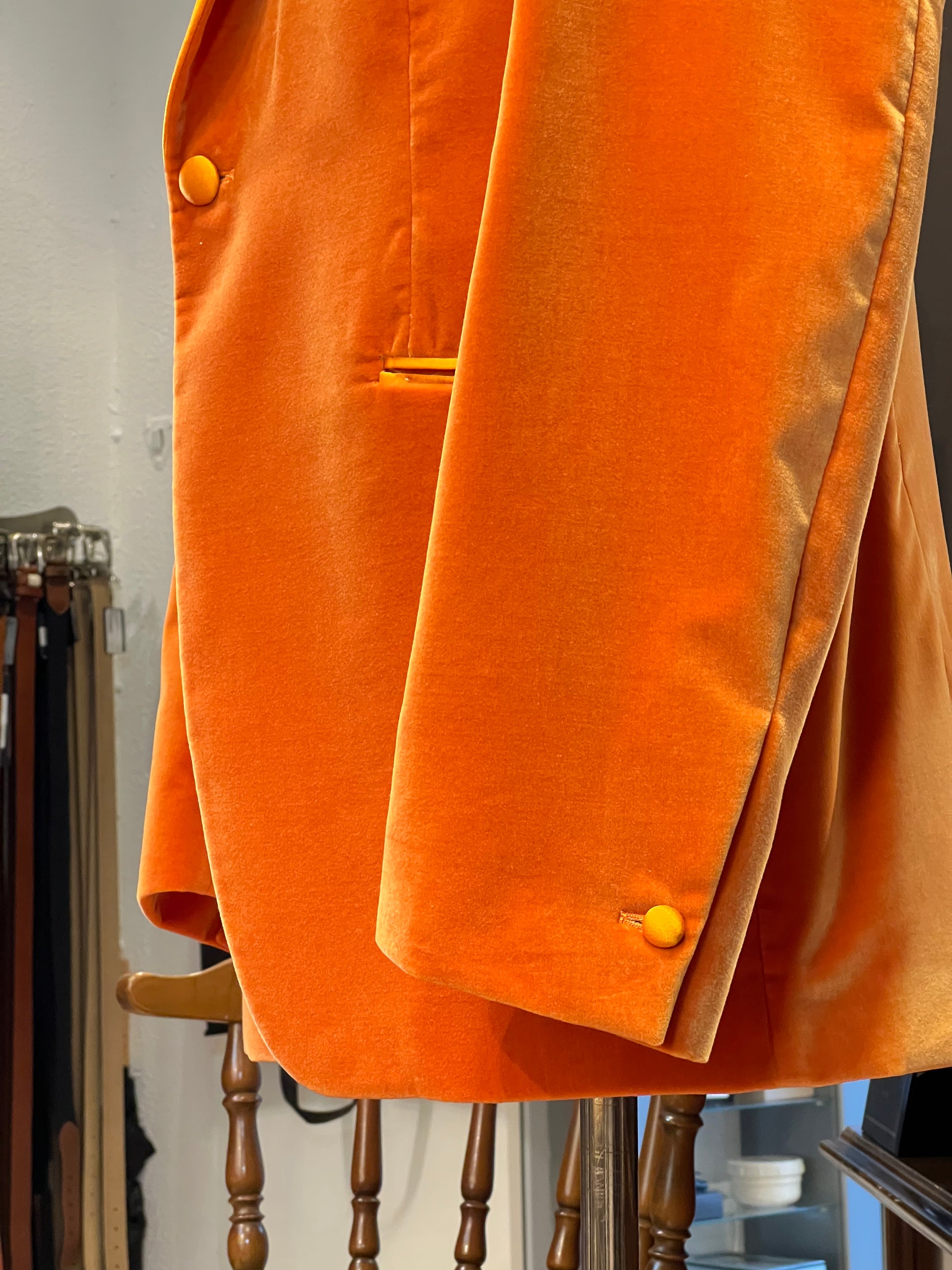 Luxury orange velvet blazer by John Blond, handcrafted with Carnet Como fabric, featuring contrasting amber peak lapels, covered buttons, and ivory satin lining — elegant statement jacket for formal or evening wear.