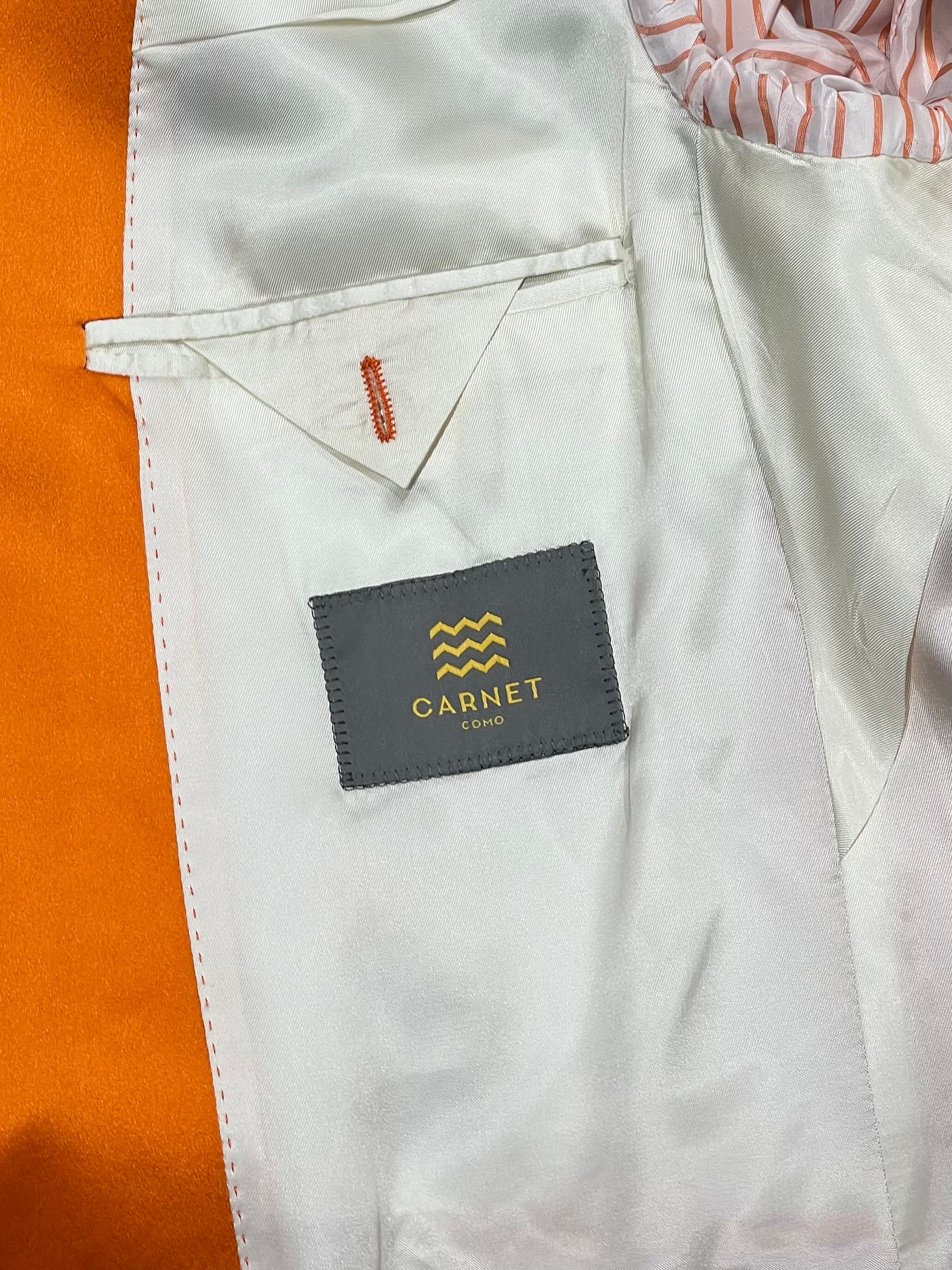Luxury orange velvet blazer by John Blond, handcrafted with Carnet Como fabric, featuring contrasting amber peak lapels, covered buttons, and ivory satin lining — elegant statement jacket for formal or evening wear.