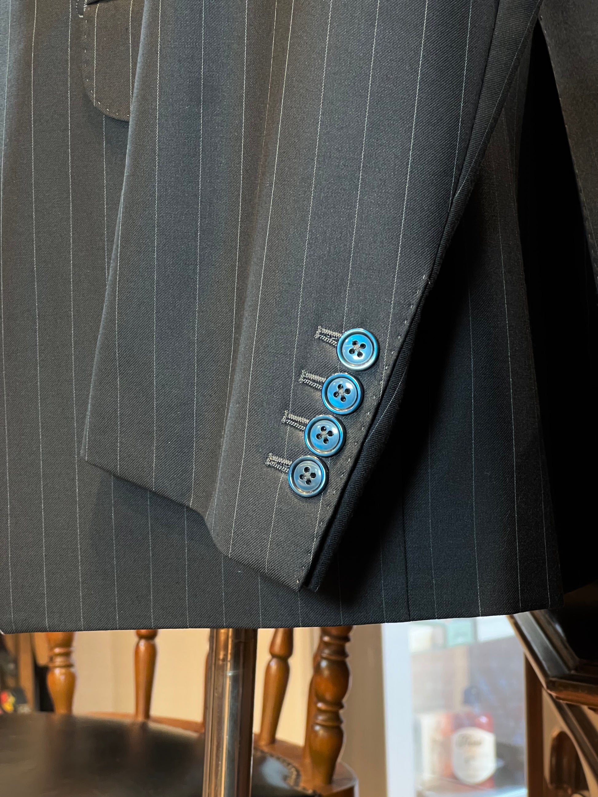 Button cuff detail on John Blond grey wool suit jacket, Italian craftsmanship.